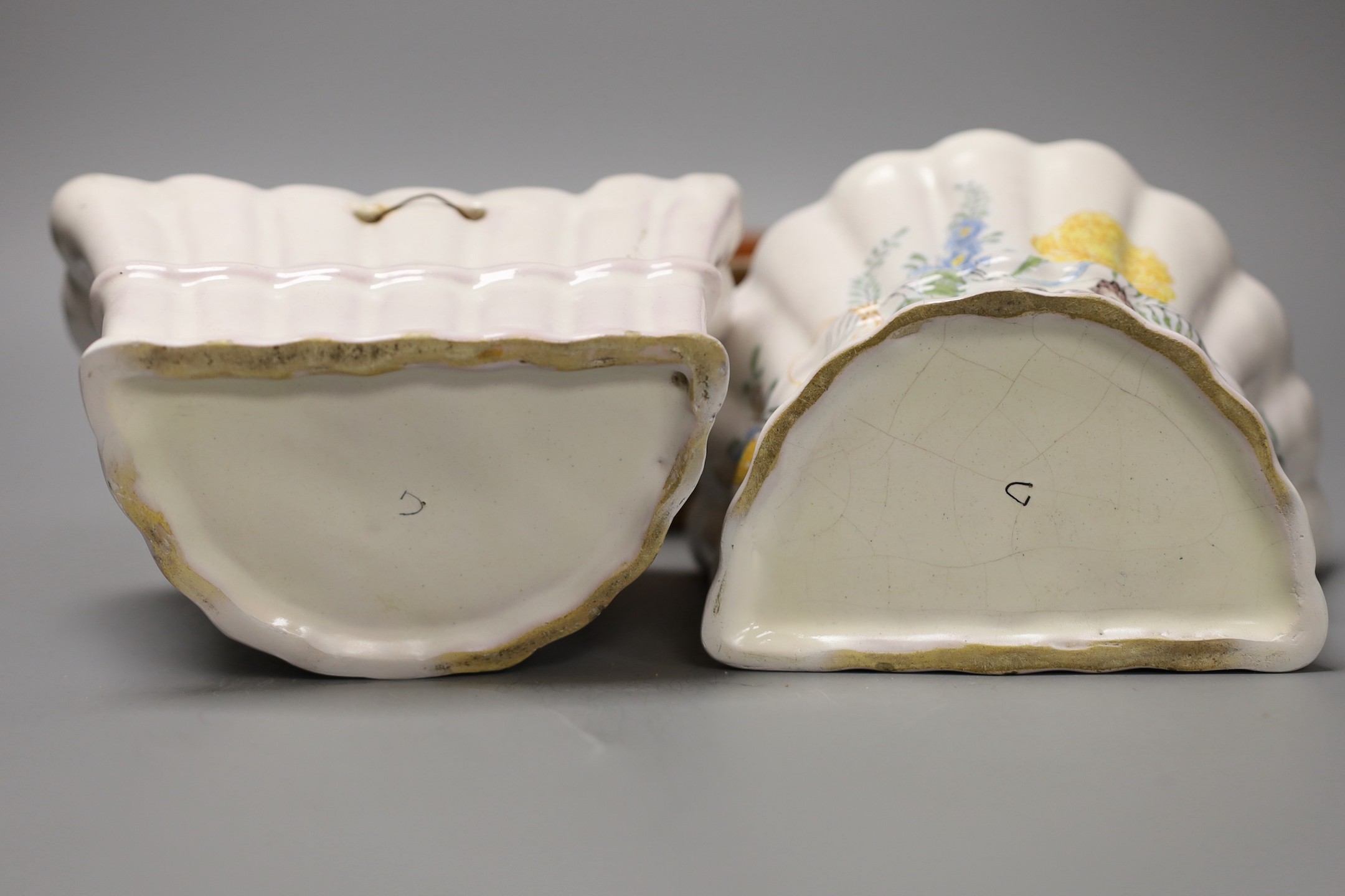 A Slipware conical bowl, 18th / 19th century, flaking to decoration, 19cm diameter, together with a pair of German faience flower decorated bough pots, late 18th century, 15.5cm wide